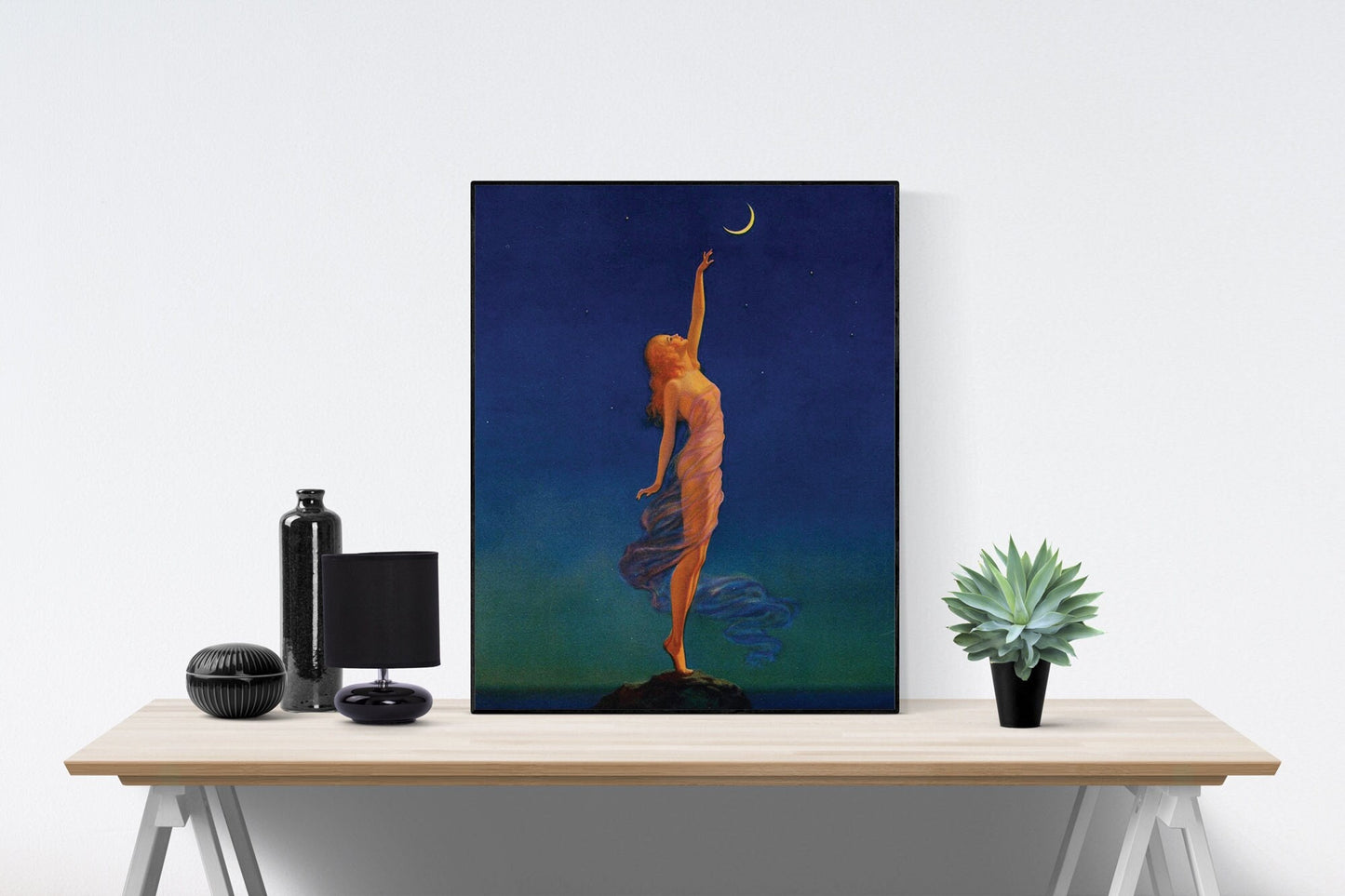 May include: A framed painting of a woman in a flowing blue dress reaching up towards a crescent moon in a dark blue night sky.