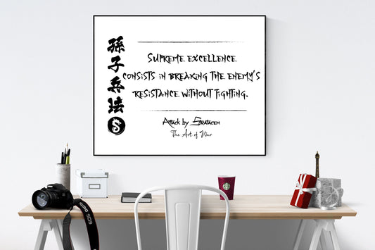 May include: A black framed print with a white background. The print features a quote in black ink that reads &#39;SUPREME EXCELLENCE CONSISTS IN BREAKING THE ENEMY&#39;S RESISTANCE WITHOUT FIGHTING.&#39; The quote is attributed to &#39;Attack by Stratagem The Art of War.&#39; The print is hanging on a white wall above a wooden desk with a white chair, a camera, a cup of coffee, a gift box, and a small Eiffel Tower figurine.