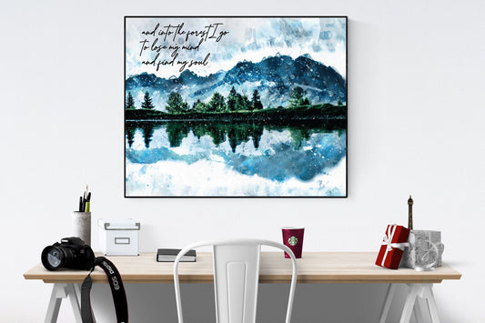 May include: A watercolor painting of a mountain lake with a reflection of the mountains in the water. The painting is framed in black and has the text &#39;and into the forest I go To lose my mind and find my soul&#39; in black text.