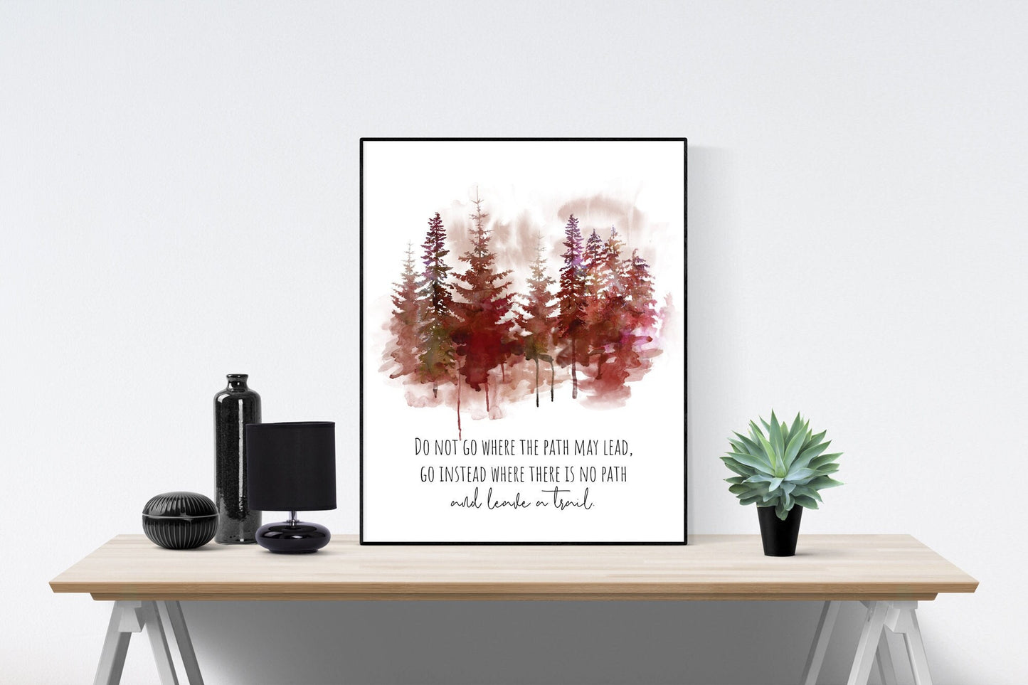 May include: A framed watercolor painting of a forest scene with a quote that reads &#39;DO NOT GO WHERE THE PATH MAY LEAD. GO INSTEAD WHERE THERE IS NO PATH and leave a trail.&#39;
