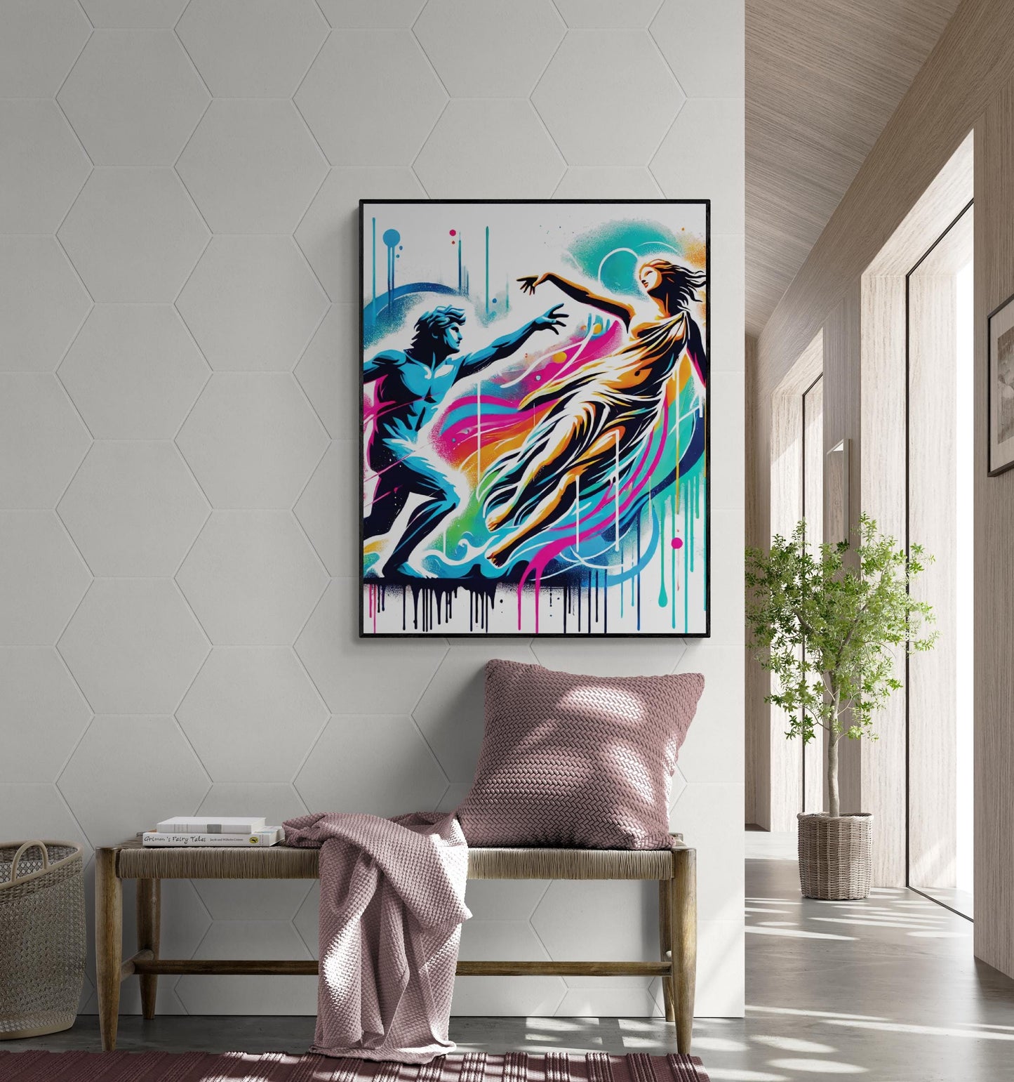 May include: A framed abstract painting with a white background and colorful paint splatters. The painting depicts two figures, one in blue and one in yellow, reaching towards each other. The painting is hanging on a white wall above a wooden bench with a pink throw blanket and a pink pillow.