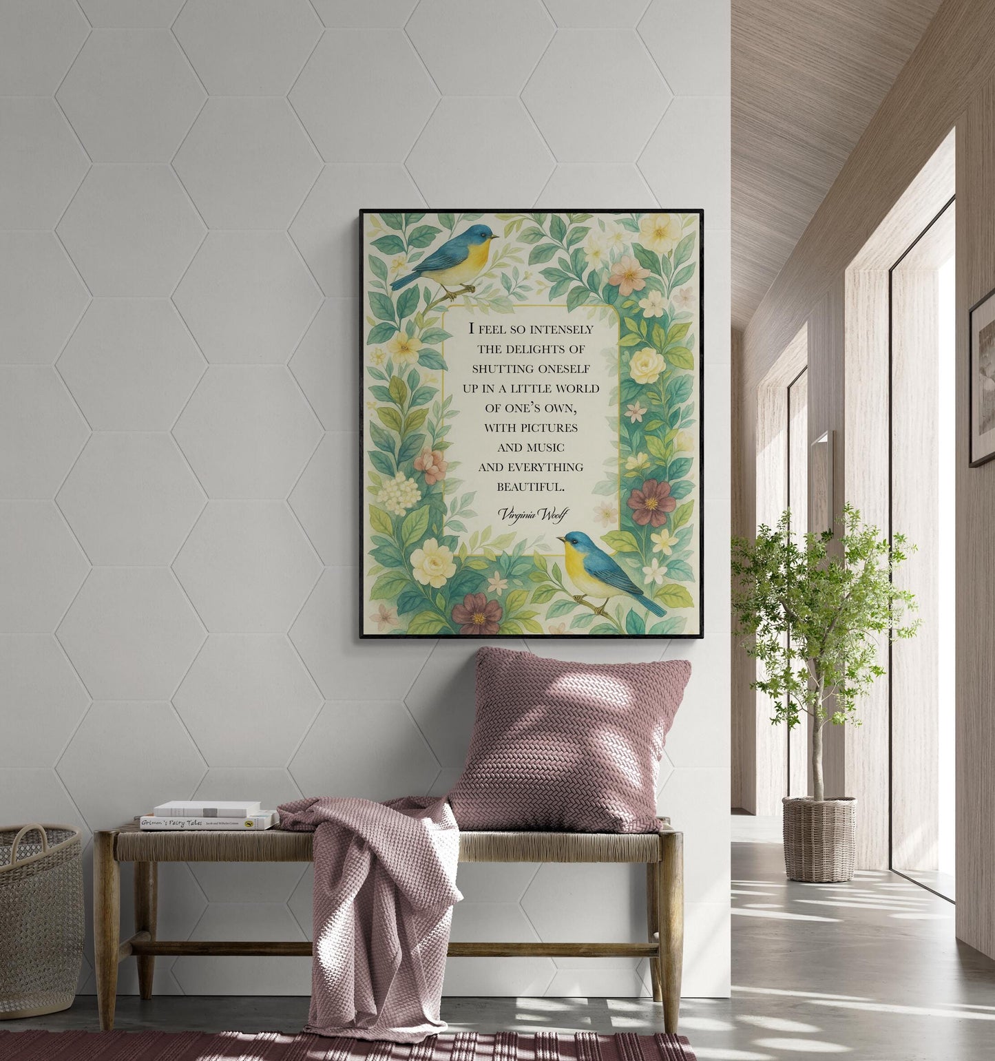 May include: A framed art print featuring a quote and floral design. The artwork showcases a quote about finding beauty in a small world, with illustrations of birds and flowers in shades of blue, yellow, and green. The print is displayed above a wooden bench with a pink cushion and blanket.