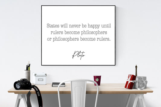 May include: A black and white framed print with the quote 'States will never be happy until rulers become philosophers or philosophers become rulers.' by Plato. The print is hanging on a white wall above a wooden desk with a white chair, a camera, a white box, a book, a red cup, a red gift box, and a small Eiffel Tower replica.