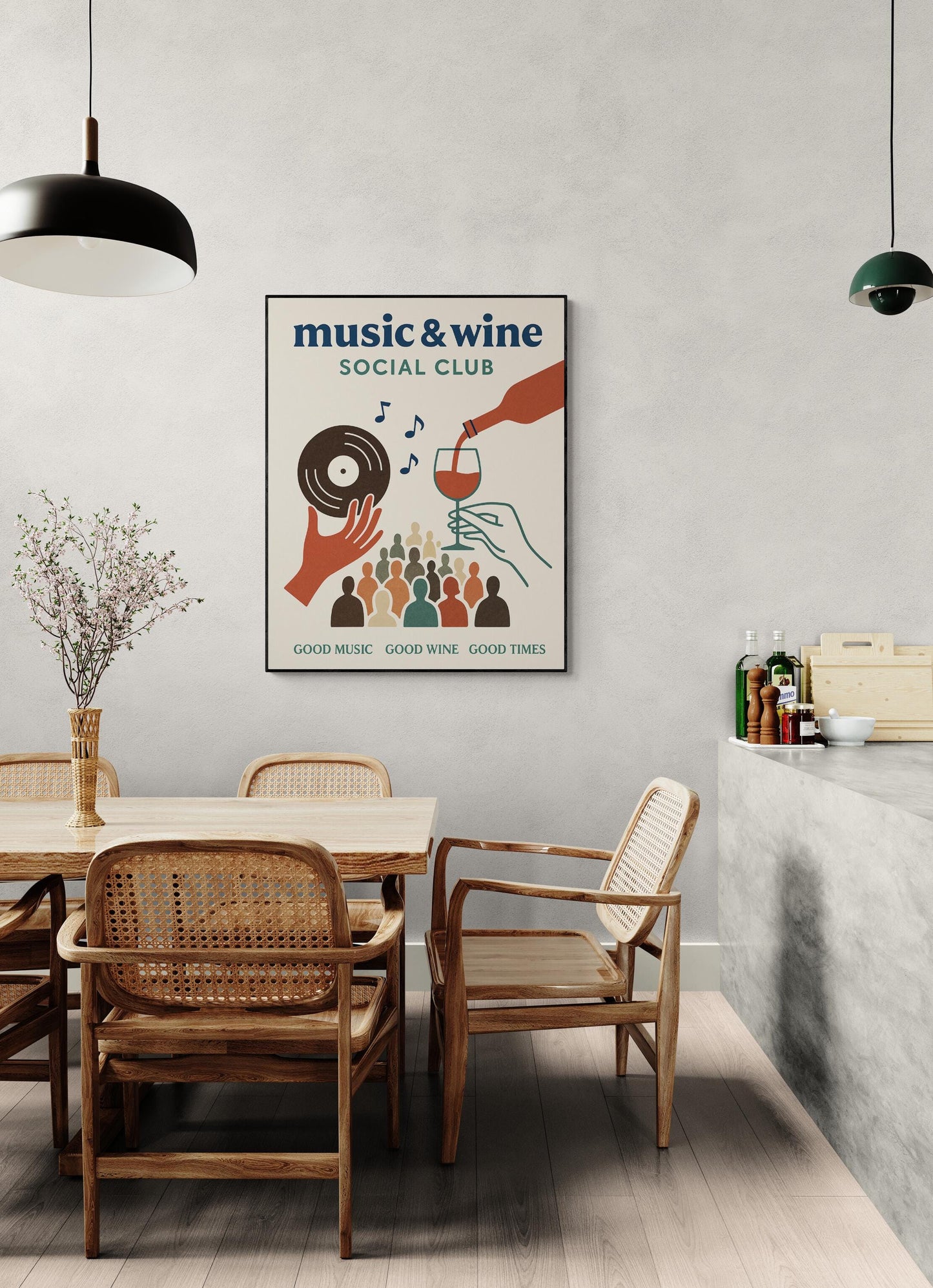 May include: A poster with a black frame, featuring the words 'music & wine social club' in blue. The poster has a hand holding a vinyl record and another hand pouring wine into a glass. Below, there are silhouettes of people. The text 'good music, good wine, good times' is at the bottom. The poster is hanging on a light gray wall.