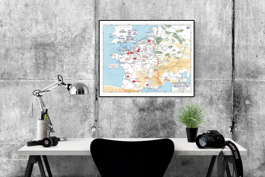 May include: A black and white map of France with red markings. The map is framed and hanging on a gray concrete wall. The map is titled 'WESTERN EUROPE 1944' and shows the Allied advance from Normandy to the German border. A desk with a lamp, headphones, a camera, and a plant is in the foreground.